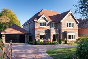 Photo of bespoke designed landscaped residential home with garage