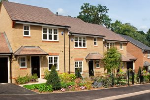 Photo of terraced affordable housing with fenced off floral gardens