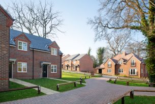 Photo of terraced affordable housing with fenced off gardens